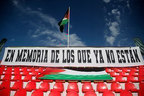 A banner displayed on the stands reads 'In memory of those who are gone' during the Chilean national championship football match between Palestino and Everton on November 23, 2023. (Photo | AFP)