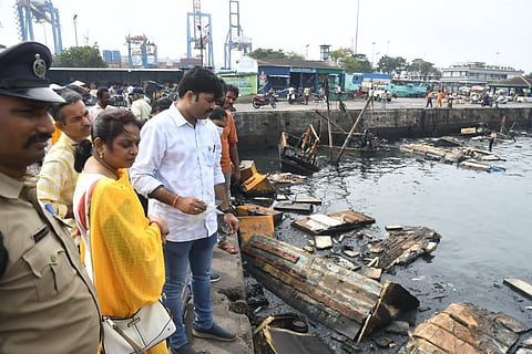Forensic team collecting samples from the jetty at the fishing harbour in Visakhapatnam where a blaze destroyed over 35 boats. Express.