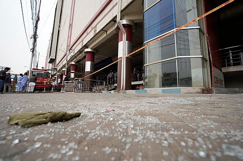Glass fragments lie in front of a commercial high-rise building in Karachi, Pakistan on Saturday, November 25, 2023. (Photo | AP)