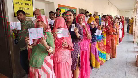 People stand in queue at a polling booth to cast their votes during Rajasthan Assembly elections, in Jodhpur, Saturday, Nov. 25, 2023. (Photo | PTI)