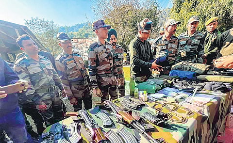 Army personnel display arms recovered from terrorists in Rajouri on Friday. (Photo | PTI)