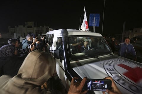 A Red Cross convoy carrying Israeli hostages heads to Egypt from the Gaza Strip at the Rafah border crossing on Sunday. (Photo | AP)