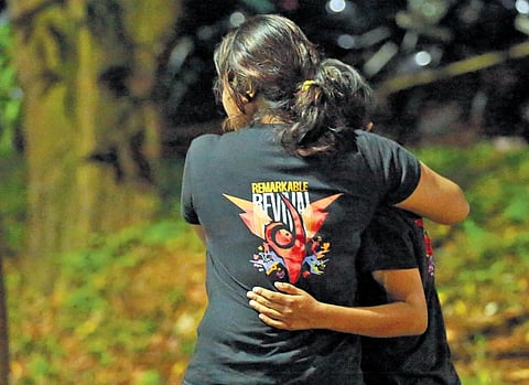 Two Cusat students comfort each other as they wait outside the Kalamassery Government Medical College Hospital, where the students injured in stampede were admitted. (Photo | T P Sooraj)