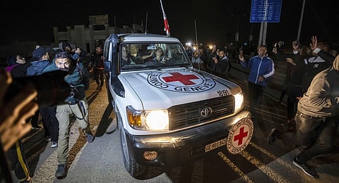 A Red Cross convoy carrying Israeli and foreign hostages heads to Egypt from the Gaza Strip at the Rafah border crossing on Sunday, Nov. 26, 2023. (AP Photo)