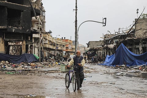 A Ravaged City: A Palestinian walks in Gaza City on Monday, Nov 27, 2023, on the fourth day of the temporary ceasefire between Hamas and Israel. (Photo | AP)
