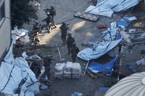 FILE - In this image taken from a video released by the Israeli Defense Forces on Wednesday, Nov. 15, 2023, Israeli soldiers walk in the area of Al-Shifa hospital in Gaza City. (Photo | AP)