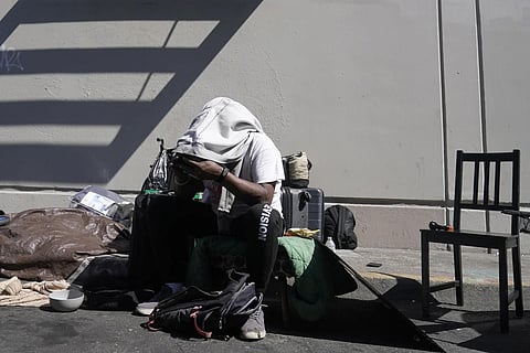 Maurice Palmer waits with his possessions as a homeless encampment is cleaned up in San Francisco, Tuesday, Aug 29, 2023. (Photo | AP)