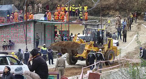 The road near the Silkyara Tunnel is being repaired during the ongoing rescue operation of the 41 workers trapped inside the under-construction tunnel, in Uttarkashi district. (Photo | PTI)