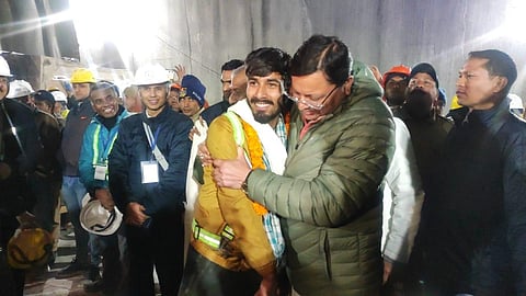 Uttarakhand Chief Minister Pushkar Singh Dhami greets rescued workers coming out of the collapsed Silkyara Tunnel. (Photo | Special Arrangement)