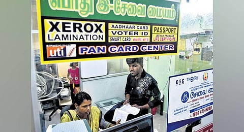 A person checking documents at an e-seva centre in Chennai following a recent WhatsApp message saying caste certificates without photos are invalid. (Photo | P Ravikumar)