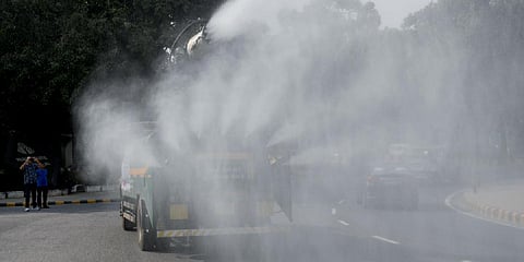 An anti-smog vehicle sprinkling water to curb air pollution as the air quality deteriorates in New Delhi (File photo | ANI)