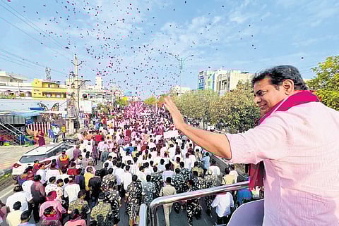 BRS working president KT Rama Rao waves to supporters during a roadshow in Sircilla on Tuesday. (Photo | Express)