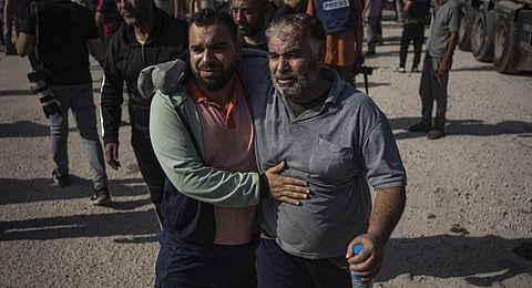 Palestinian day laborers in Israel arrive in the Gaza Strip at the Kerem Shalom crossing after being brought by Israeli authorities. (Photo | AP)