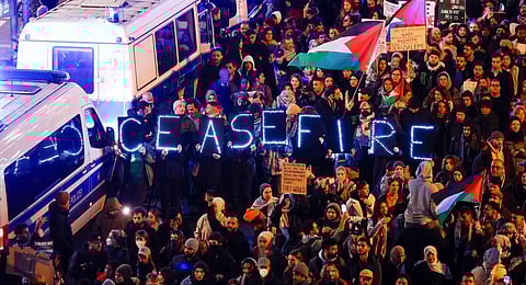 Demonstrators carry a sign reading 'Ceasefire' during a protest rally in support of Palestinians under the slogan 'Free Palestine' in Berlin. (Photo | AFP)