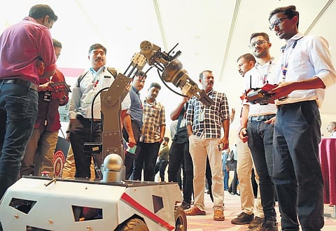 Visitors taking a look at the bomb defusal robot devoloped by the robotic team of Kerala Police Cyberdome at the c0c0n conference, Oct 2023. (Photo | T P Sooraj, EPS)