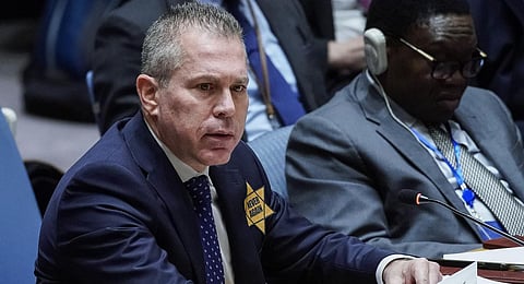 Israel’s U.N. Ambassador Gilad Erdan wears a yellow Star of David that reads 'Never Again' in honor of those killed in the unprecedented attack by Hamas.(Photo | AP)