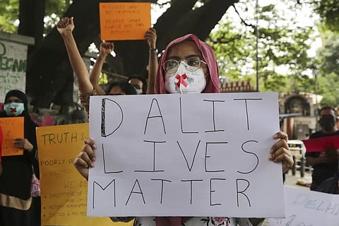 FILE - Demonstrators hold signs during a protest condemning the alleged gang rape and killing of a Dalit woman, in Bengaluru, India, Sunday, Oct. 4, 2020. (Photo | AP)