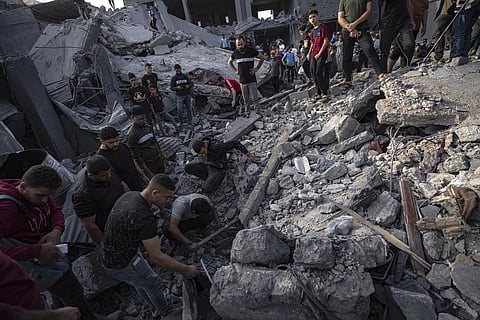 Palestinians look for survivors of the Israeli bombardment in the Maghazi refugee camp in the Gaza Strip. (Photo | AP)