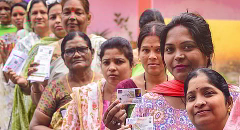 Voters show their identification cards as they wait in a queue to cast their votes for the 1st phase of Chhattisgarh Assembly elections, at a polling station in Jagdalpur, Bastar district.(Photo |PTI)