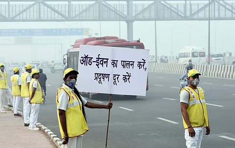 Volunteers holding a Placard on the first day of the Odd Even Scheme at NH24 Near Akshardham in New Delhi. | (Photo | Parveen Negi/EPS)