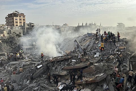 FILE - Palestinians look for survivors following Israeli airstrike in Nusseirat refugee camp, Gaza Strip, Oct. 31, 2023. (Photo | AP)