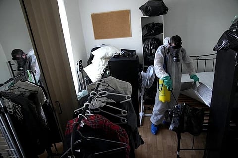 Pest control technician Lucas Pradalier sprays an insecticide under a mattress Wednesday, Oct. 4, 2023 in a Paris apartment. (Photo | AP)