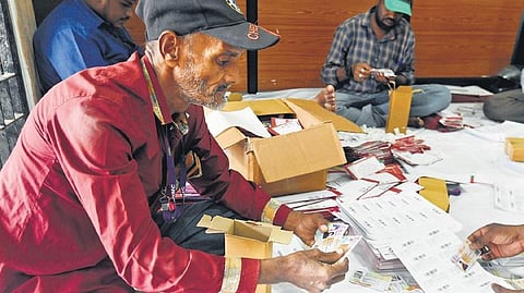 Employees of the GHMC’s Entomology department are seen packing voter IDs for deliveries at the GHMC head office in Hyderabad | Vinay Madapu