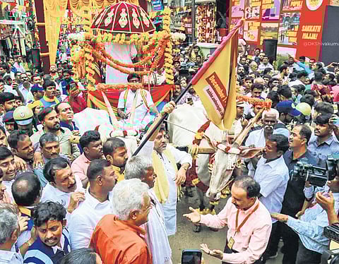 Deputy Chief Minister DK Shivakumar flags off a bullock cart procession at Chickpet in Bengaluru on Thursday | express