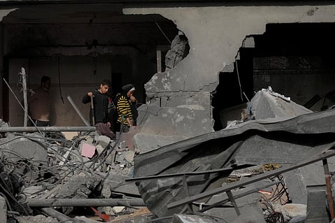Palestinians stand in their home destroyed in the Israeli bombardment of Al Zawayda, central Gaza Strip, on Sunday, December 10, 2023. (Photo | AP)