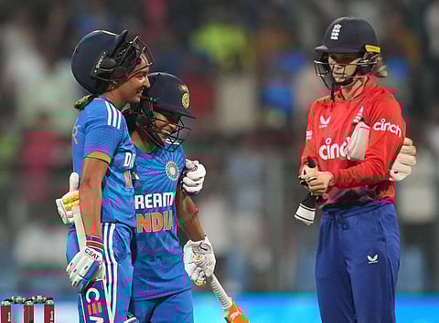 India's Harmanpreet Kaur and Amanjot Kaur celebrate after winning the 3rd T20I cricket match against England, at Wankhede Stadium, in Mumbai, on Dec. 10, 2023 | PTI