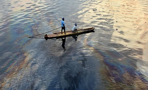 Fishermen seen sailing in oil spilled Ennore creek at Ennore after recent cyclone hit in Chennai. (Photo | P. Ravikumar)