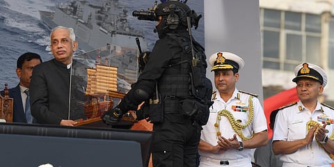 A naval commando presenting a souvenir to Governor S Abdul Nazeer | express