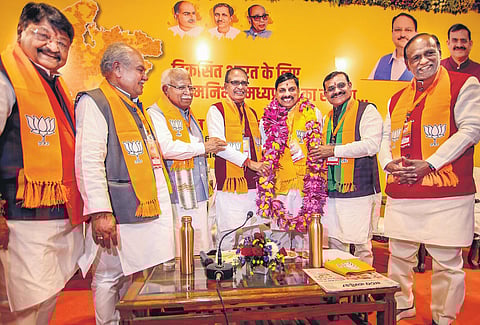 Madhya Pradesh CM-designate Mohan Yadav being greeted by outgoing CM Shivraj Singh Chouhan, state BJP chief V D Sharma and others in Bhopal on Monday | pti