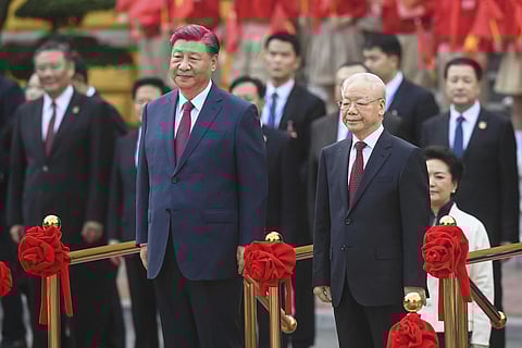 China's President Xi Jinping (L) and Vietnam's Communist Party General Secretary Nguyen Phu Trong, attend a welcome ceremony at the Presidential Palace in Hanoi, Dec. 12, 2023. (AP Photo)