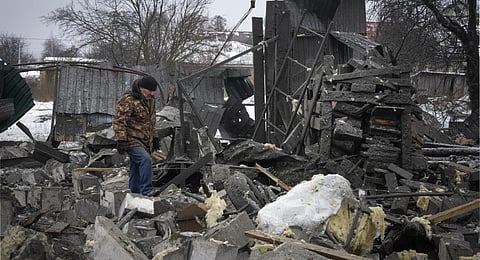 A local resident passes by debris at the site of a private house ruined in the Russian missile attack in Kyiv. (Photo | AP)