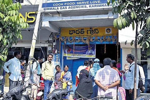 Consumers throng a LPG distributor in Karimnagar on Tuesday to to update their KYC