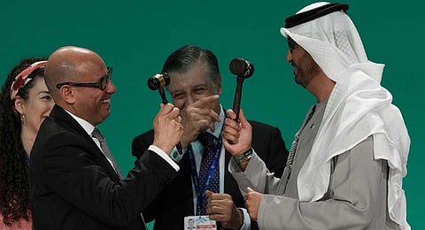 COP28 President Sultan al-Jaber and UN Climate Chief Simon Stiell both hold gavels at the end of the COP28 U.N. Climate Summit, Wednesday, Dec. 13, 2023, in Dubai, United Arab Emirates. (AP)