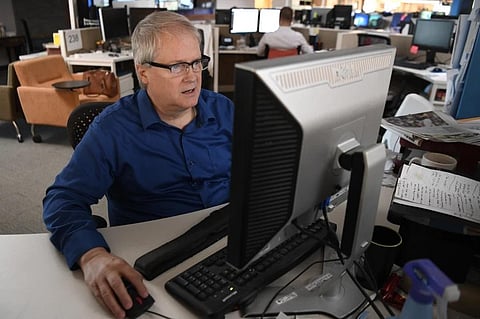 Reporter Kirk Mitchell at his desk in The Denver Post’s newsroom in this photograph taken on August 23, 2017, in Denver. (Photo | AP)