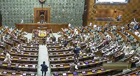 A visitor jumps in the Lok Sabha chamber from the public gallery during the Winter session of Parliament, in New Delhi, Wednesday, Dec. 13, 2023. (PTI)