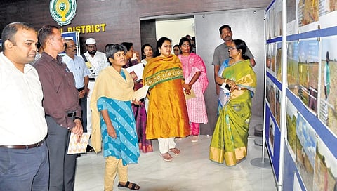 Central team goes round a photo exhibition on the cyclone damage set up at the Collectorate of Kurnool on Wednesday I express