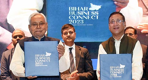 Bihar CM Nitish Kumar with Bihar Minister of Industries Samir Kumar Mahaseth releases a coffee table book during Bihar Business Connect 2023 in Patna, Thursday, Dec. 14, 2023. (PTI)