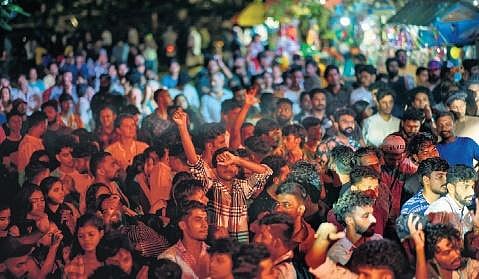 Crowd swaying to Lecomte de Brégeot’s music at a concert in Fort Kochi