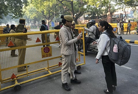 Security personnel check a vehicle near the Parliament House after a security breach in Parliament. (Photo | PTI)
