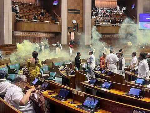 Two protesters jumped into the Lok Sabha chamber from the public gallery, released yellow gas from canisters and shouted slogans. (Screengrab | SansadTV)