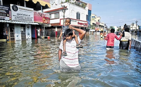 People wade through flooded streets at Mudichur. (Photo | P Ravikumar)