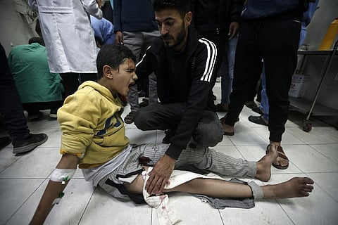 A Palestinian boy wounded in Israeli airstrikes on a U.N.-run school receives treatment at the Nasser hospital in the town of Khan Younis, southern Gaza Strip. (Photo | AP)