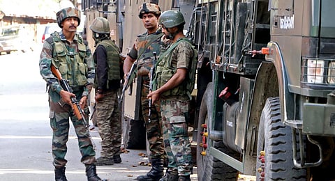 Army personnel stand guard at the site where an encounter took place between security forces and militants, in the Kokernag area of Anantnag on Sept 2023.(Photo | ANI)