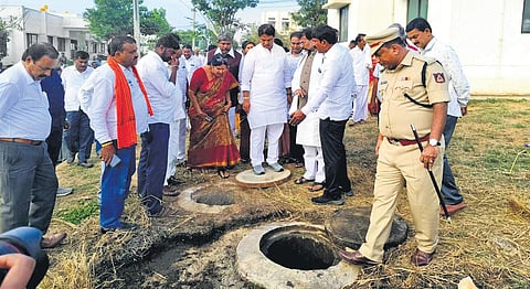 Leader of Opposition in the Assembly R Ashoka inspects the septic tank at the residential school in Malur on Monday. (Photo | Express)