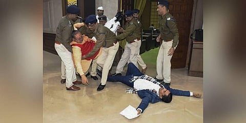 Jharkhand BJP MLAs Bhanu Pratap Sahi and Biranchi Narayan being removed by Assembly Marshals after their protest inside the assembly, in Ranchi. (Photo | PTI)