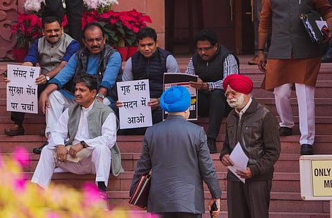 Suspended MPs protest against their suspension at the entrance of Parliament during ongoing Winter session, in New Delhi on Monday | PTI